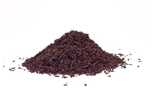 a scattering of black tea on a white background