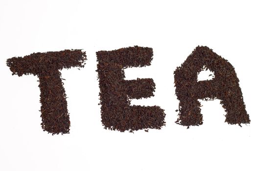 a scattering of black tea on a white background