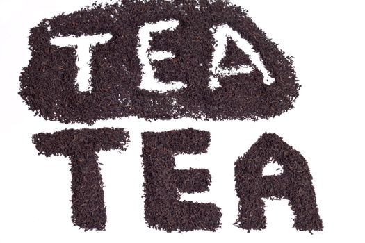 a scattering of black tea on a white background