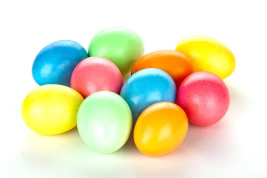 eastern eggs in different colours in a basket with a rabbit