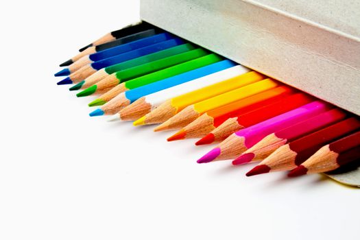 a bunch of colored pencils on a light background