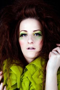 young beautiful woman with an extreme colorfull make up portrait