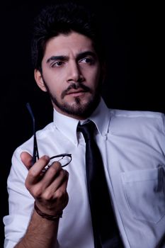 young successful business man with a suit isolated on black background