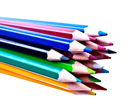 a bunch of colored pencils on a light background