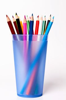 a bunch of colored pencils on a light background