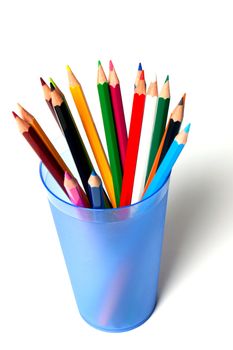 a bunch of colored pencils on a light background