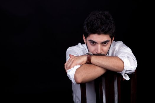 young successful business man with a suit isolated on black background