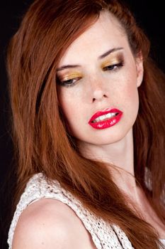 portrait of a beautiful young woman with red hair and red lips