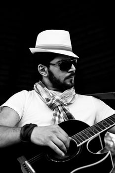 young man is playing a guitar and singing