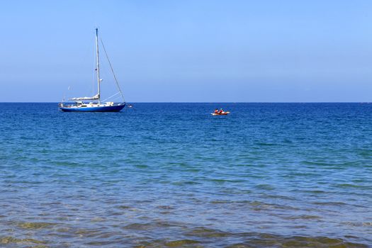 Sail boat in the tropical ocean near Maui coast