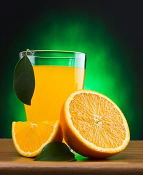 orange juice in a glass on a table with oranges