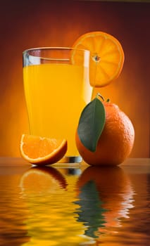 orange juice in a glass on a table with oranges