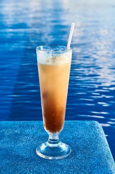 Long island iced tea cocktail near the swimming pool