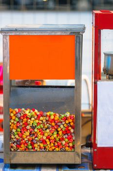 Little candy balls in machine closeup