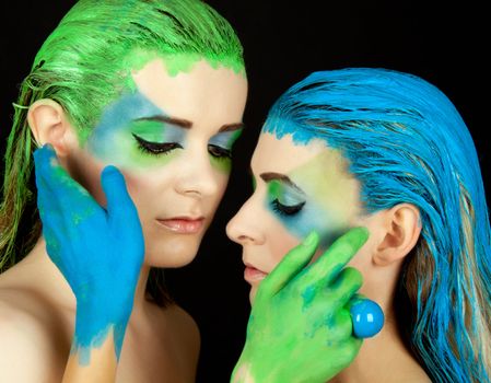 young beautiful woman with an extreme colorfull make up portrait