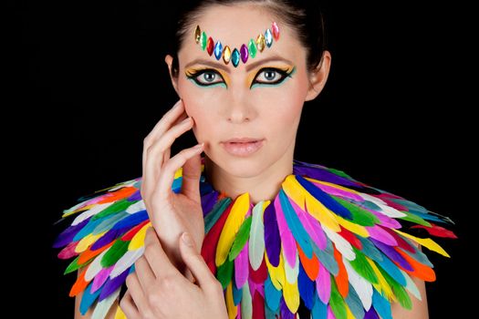 young beautiful woman with an extreme colorfull make up portrait