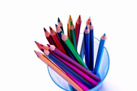 a bunch of colored pencils on a light background