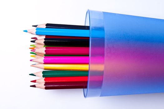 a bunch of colored pencils on a light background