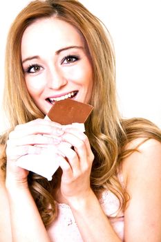 young beautiful woman with a bright smile is eating chocplate