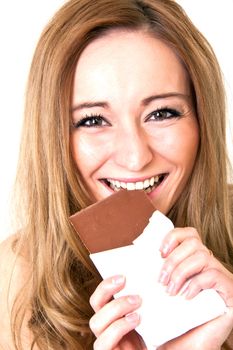 young beautiful woman with a bright smile is eating chocplate