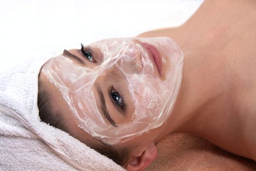 young beautiful woman with a towel doing wellness