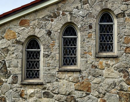 Three church windows arranged at an angle.