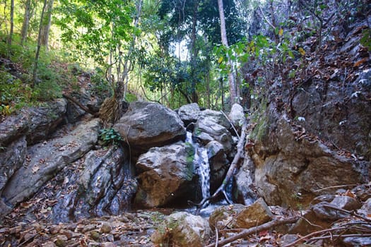 small waterfall cascade in the stream in northern thailand