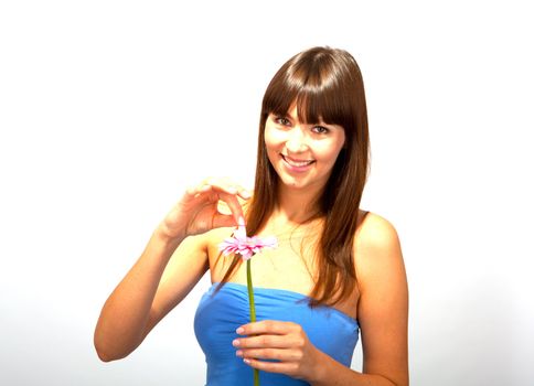 young beautiful brunette woman with a flower happy