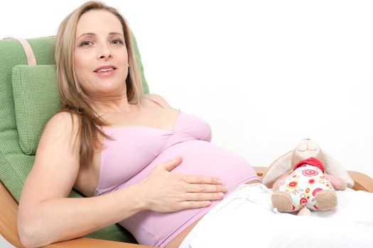 older pregnant woman looks forward to her baby