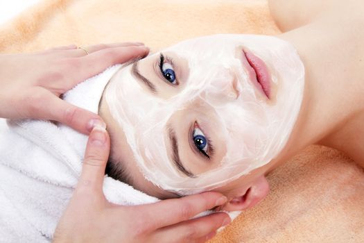 young beautiful woman with a towel doing wellness