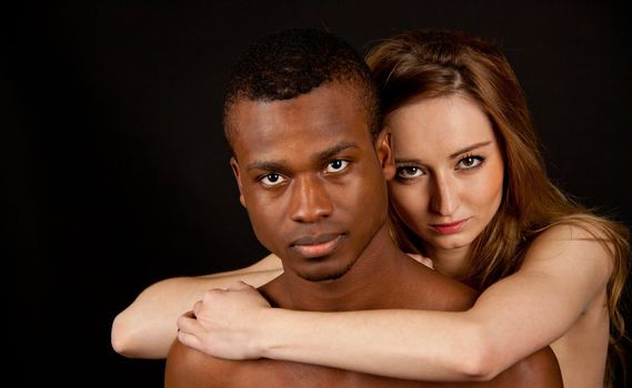 young beautiful caucasian woman with a man with dark skin couple lovers