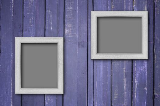 Two white wood picture frame on Purple color paint plank wall for background