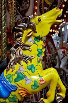 Colorful merry go round horses at the amusement park.