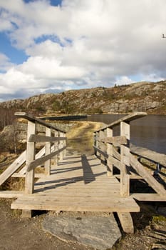 Picture of a pathway with a bridge on a mountain