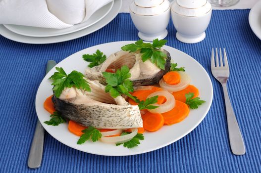 Pieces of fish cooked with carrots and onions 