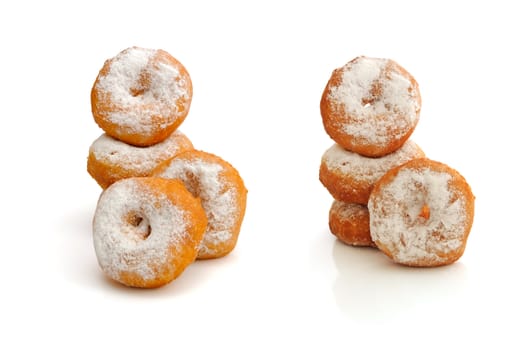 Fried donuts in powdered sugar on a white background (isolated)