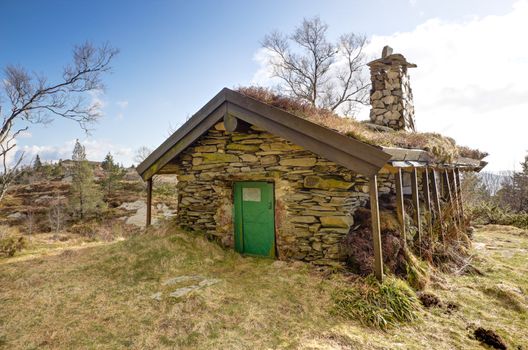 Picture of and old stone cottage up in a mountain
