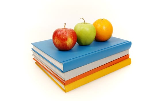 A book stack with some apples on it