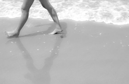 Legs walk on sand in black and white dreaming style 