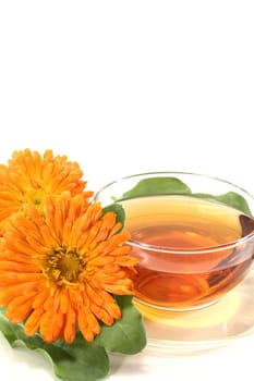marigold tea with Calendula and leaves on a light background