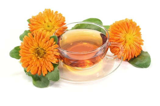 fresh marigold tea with flowers and leaves on a bright background