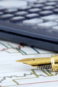 A nib of a Fountain pen on sheet of financial data. shallow depth of field.