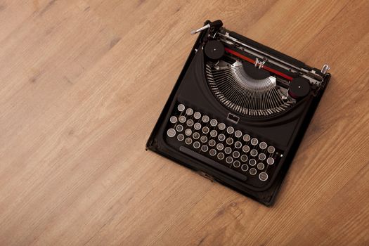 Top view of a vintage typewriter over a wood floor