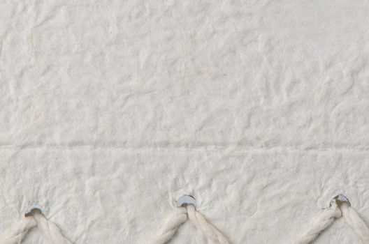 Cream textured paper closeup, can be used as a background.