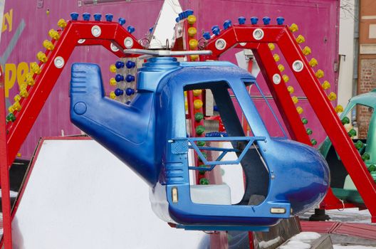 Amusement park rides colorful carousel spin helicopter.