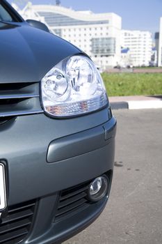 large headlight of modern grey metallic car