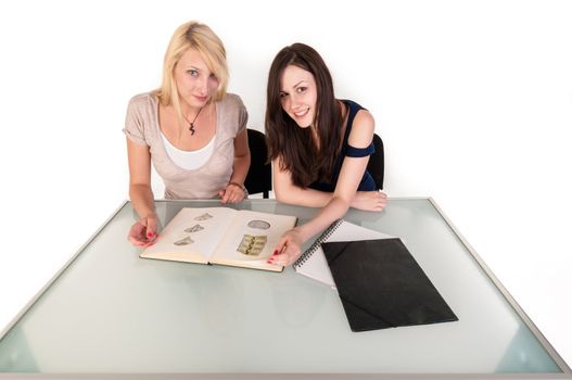 Two beautiful student girls getting ready for school isolated