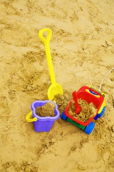 bright child's toys in sand on a playground