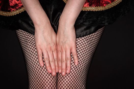 Legs of a youn woman against dark background closeup