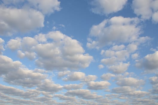 beautiful cloudy blue spring sky sun-lit background.